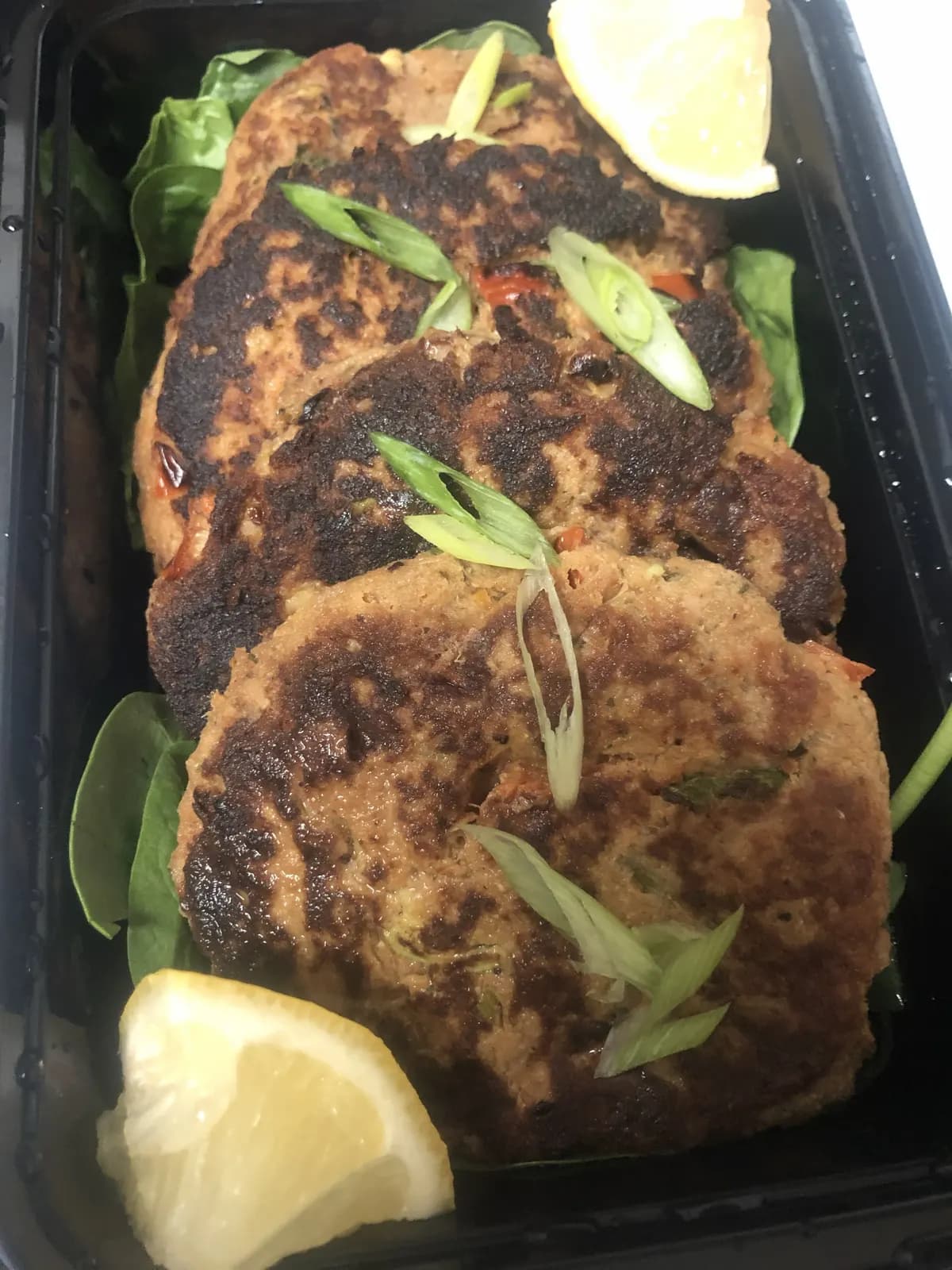 Crab cake meal with lemon garnish
