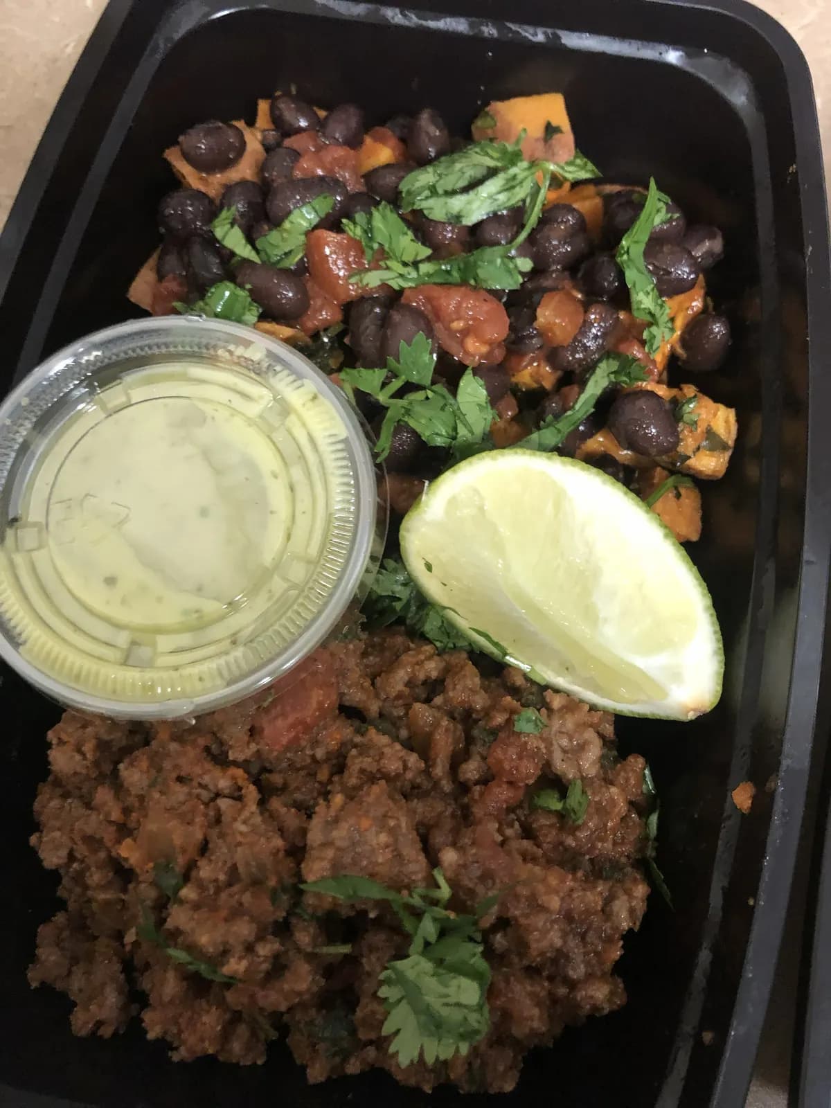 Meal prep plate with beans, rice, and lime
